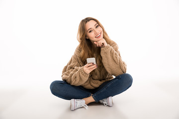 Happy cute lady chatting by mobile phone.