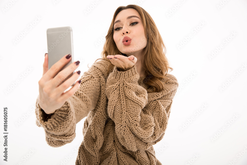 Sticker Lady dressed in sweater make selfie by phone blowing kisses.