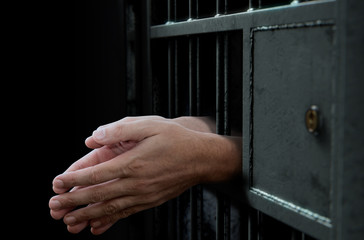 Fototapeta na wymiar Jail Cell Door And Hands