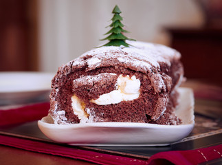 A yule, Christmas chocolate log cake with rich dairy cream.