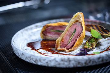 Grilled steak meat with potato gratin and glass of red wine