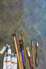 artists brushes and oil paints. Palette with paintbrush and palette-knife