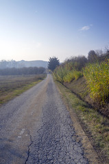 Fototapeta na wymiar Country road along the hills. Color image