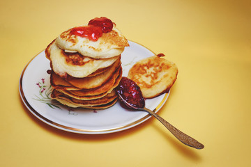 Pile of pancakes with jam on top