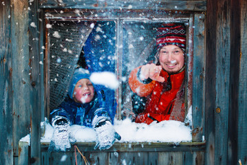 Winter Lifestyle Concept - Happy Family Having Fun at Countryside - People playing with Snow...