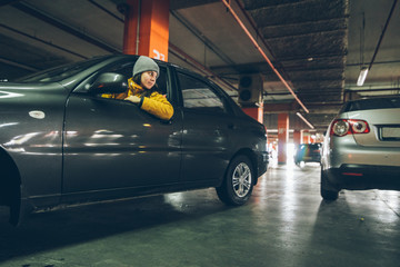 woman parking car in undergroud parkinng