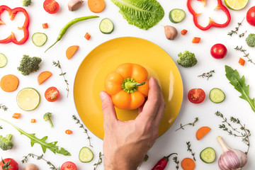 man putting bell pepper on plate