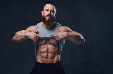 Bearded bodybuilder dressed in a tank top.
