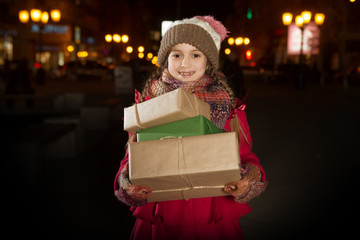 beauty Little girl  with christmas gift in city. Christmas time.  Happy Christmas holidays! 
