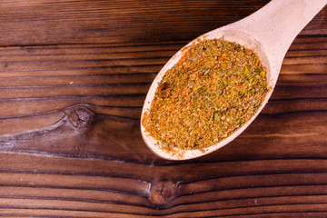 Mix of different seasonings in wooden spoon. Top view