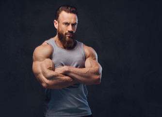 Bearded bodybuilder dressed in a tank top.