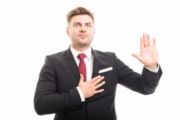 Portrait of handsome corporate business man taking oath