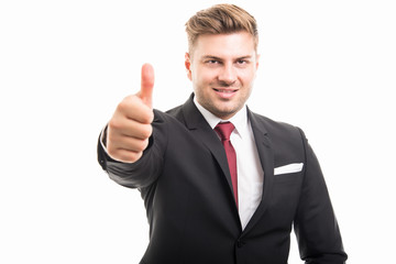 Portrait of handsome corporate business man showing thumb up