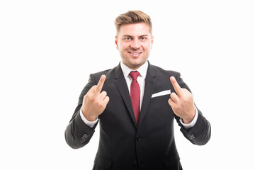 Handsome corporate business man showing middle finger with both hands