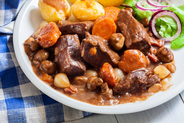 Beef Bourguignon stew served with baked potatoes