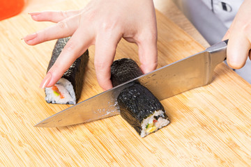 Chef cuts rolls, hands close-up