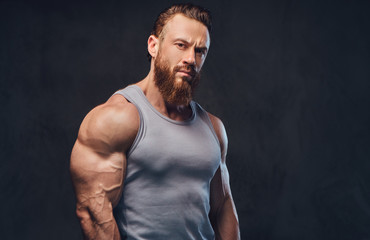 Bearded bodybuilder dressed in a tank top.