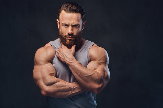 Bearded bodybuilder dressed in a tank top.