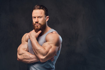 Bearded bodybuilder dressed in a tank top.