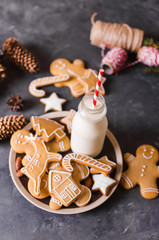 Milk and cookies. Gingerbread  cookies on a gray background.  Christmas cookies.  Ginger men