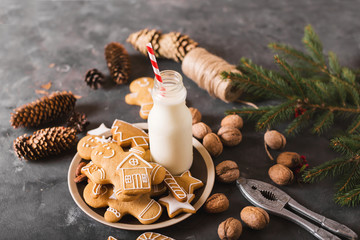 Milk and cookies. Gingerbread  cookies on a gray background.  Christmas cookies.  Ginger men