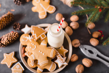 Milk and cookies. Gingerbread  cookies on a gray background.  Christmas cookies.  Ginger men