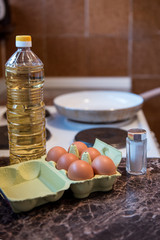 Preparing meal, frying eggs