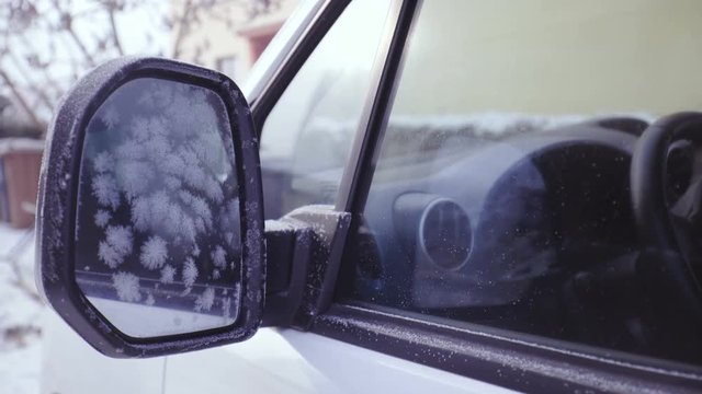 Zoom in on car side mirror with frost 4K