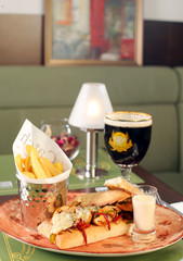 Bistro meal with rich sandwich, fries, beverage