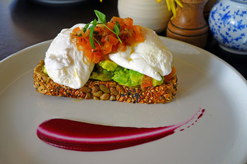 Multigrain avocado toast with poached eggs on top