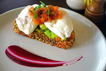 Multigrain avocado toast with poached eggs on top