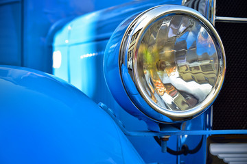 Headlight lamp of blue retro classic car