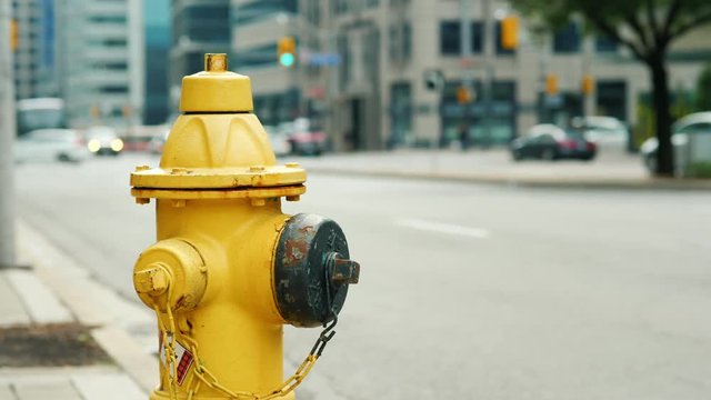 Fire hydrant in the background of a busy street in Toronto