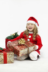 Little girl red dress santa hat with gift on white background