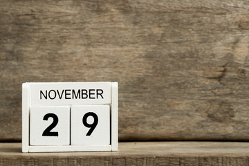 White block calendar present date 29 and month November on wood background
