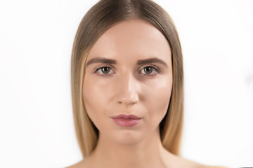 Obraz premium Beautiful face of young adult woman with clean fresh skin - isolated on white
