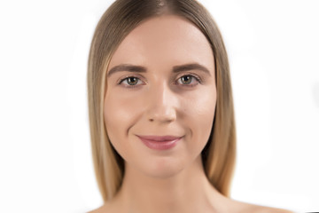Obraz premium Beautiful face of young adult woman with clean fresh skin - isolated on white