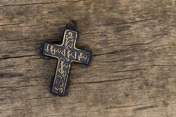 Christian Cross on old wooden table. Religion concept. Top view