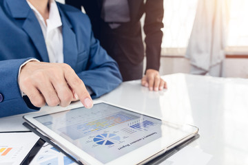 Investor executive pointing growth by graph and discussing plan financial graph data my team at office. Business team recheck summary or annual audit of financial information. Business team meeting.