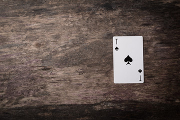 playing cards dark ace with copyspace on the wooden table