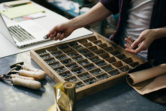 Crop worker choosing printing letters