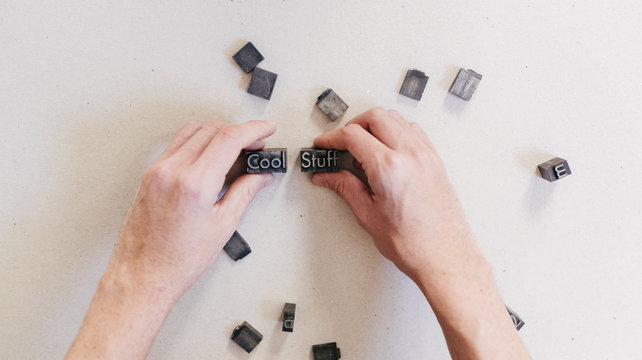 Crop man arranging printing letters