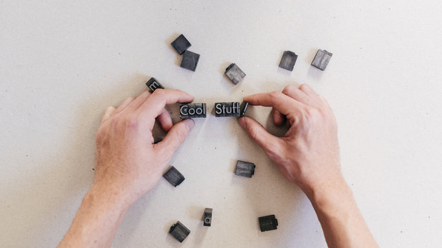 Crop man arranging printing letters