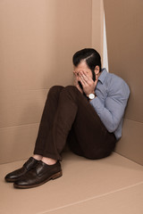 depressed man crying in box