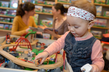 little girl having fun in a toy store