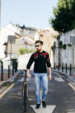 Stylish man with bicycle on street