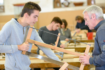 carpenter with apprentice in training period