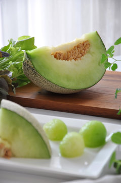 Piece of Honeydew Melon on Wooden Board