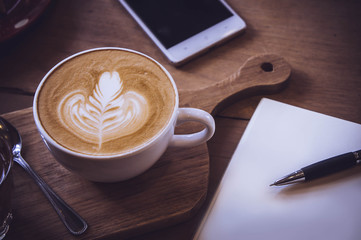 coffee cup and tasty cake on wood table and Blank paper waiting for ideas , coffee time work