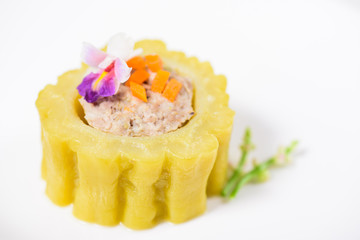 Obraz na płótnie Canvas Boiled bitter gourd with pork decorated with carrot and flower,food styling